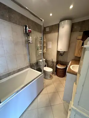 a bathroom with a tub and a toilet and a sink at Luxury 3-BR apartment & sky terrace in Sveti Vlas