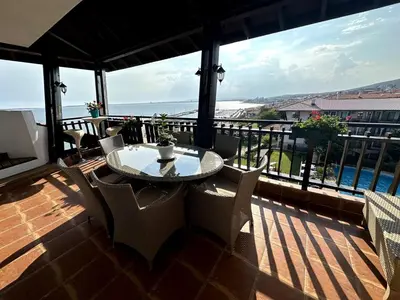 a patio with a table and chairs on a balcony at Luxury 3-BR apartment & sky terrace in Sveti Vlas