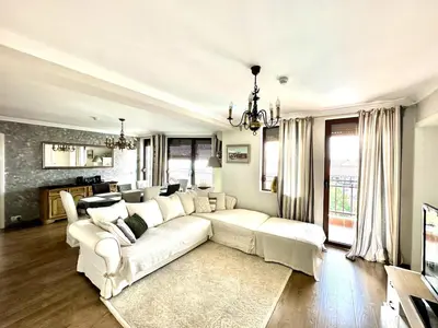 a living room with a white couch and a tv at Luxury 3-BR apartment & sky terrace in Sveti Vlas