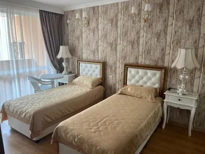 a hotel room with two beds and a table at Apart Sweet Homes 5 - Apartments for guests in Sunny Beach