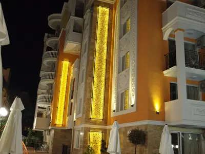 a building with a lit up facade at night at Apart Sweet Homes 5 - Apartments for guests in Sunny Beach