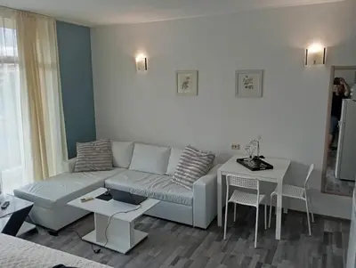a living room with a couch and a table at Sunshine2 in Sunny Beach