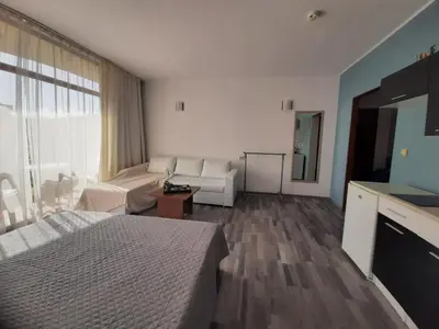 a hotel room with a bed and a couch at Sunshine2 in Sunny Beach