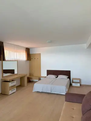 a large bedroom with a bed and a desk at Byala sea view apartment Studio in Byala