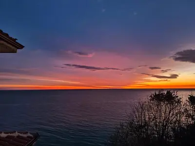 a view of the ocean at sunset at Byala sea view apartment Studio in Byala