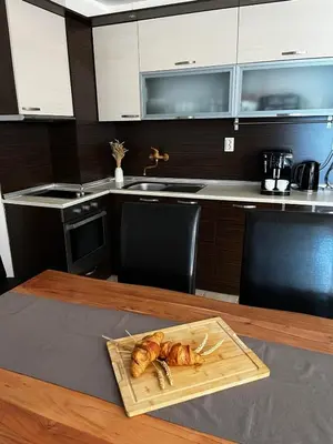 a wooden table with a plate of chickens on it at Blue Bay House in Nesebar