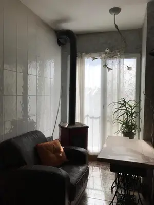 a living room with a wood stove and a couch at Burgas Biju in Burgas City