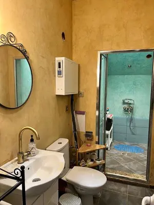 a bathroom with a toilet and a sink and a shower at Burgas Biju in Burgas City