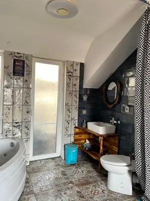 a bathroom with a tub and a toilet and a sink at Burgas Biju in Burgas City