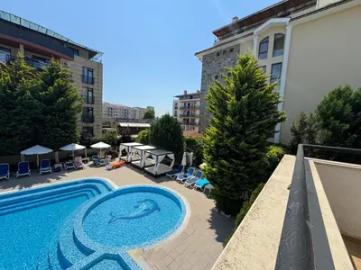a swimming pool with a dolphin painted on the side of a building at VP Villa Valencia in Sunny Beach