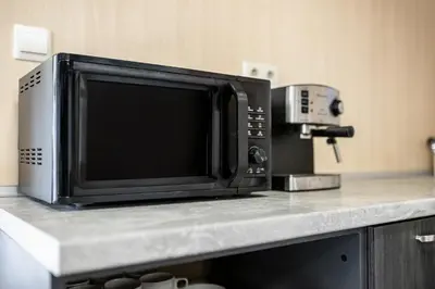 a microwave sitting on top of a kitchen counter at Heart of the city Hostel in Varna City