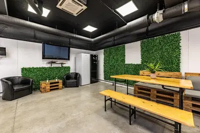 a room with benches and a green wall at Heart of the city Hostel in Varna City