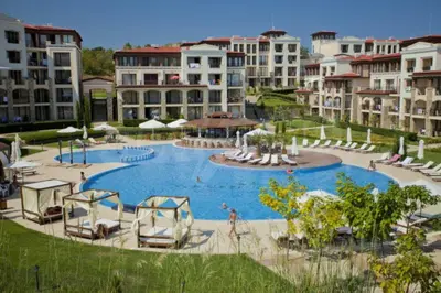 a large swimming pool in a resort with buildings at Studio Vanita in Sozopol