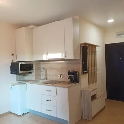 a kitchen with white cabinets and a microwave at Atlantic in Pomorie