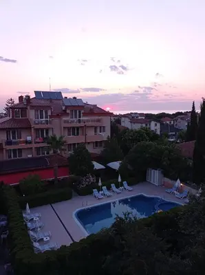 a view of a swimming pool with chairs and a building at Studio Juli in Lozenets