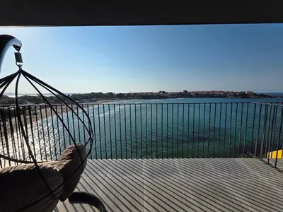 a person in a hammock overlooking a body of water at Магията на Созо in Sozopol
