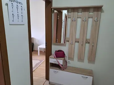 a closet with a red bag sitting on a shelf at Двустаен апартамент в Славейков in Burgas City