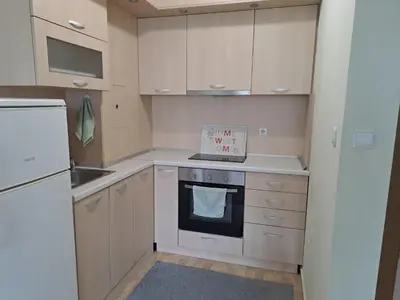 a kitchen with white cabinets and a white stove top oven at Двустаен апартамент в Славейков in Burgas City