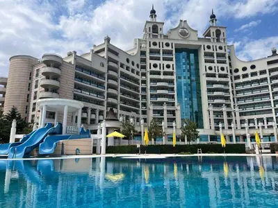 a large building with a water slide in front of it at Luxurious Apartment with sea view in Pomorie