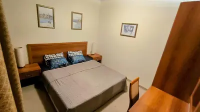 a bedroom with a bed with blue pillows at Luxurious Apartment with sea view in Pomorie