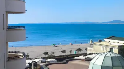 a view of a beach and the ocean from a building at Luxurious Apartment with sea view in Pomorie