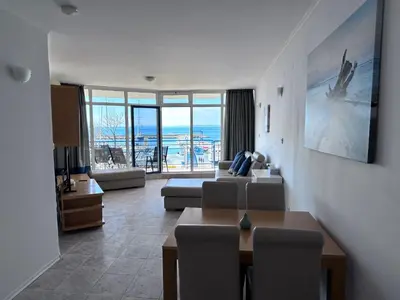 a living room with a couch and a table at Vega Stevi Vlas - Beachfront in Sveti Vlas