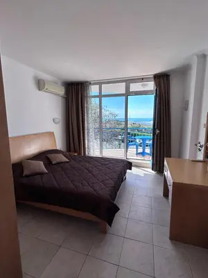 a bedroom with a bed and a large window at Vega Stevi Vlas - Beachfront in Sveti Vlas
