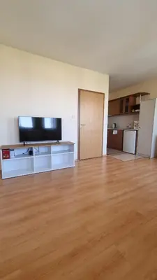 an empty living room with a flat screen tv at Studio in Relax Complex, Sveti Vlas in Sunny Beach