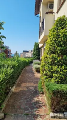 a cobblestone path in front of a building at Studio in Relax Complex, Sveti Vlas in Sunny Beach