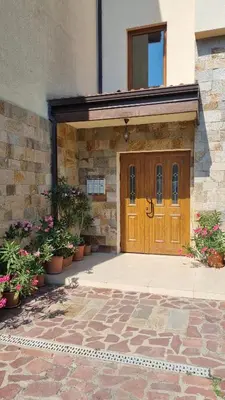 a wooden door of a building with potted plants at Studio in Relax Complex, Sveti Vlas in Sunny Beach