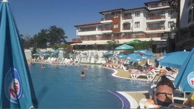 a resort swimming pool with people in the water at Gardenia Hills Studio in Sunny Beach