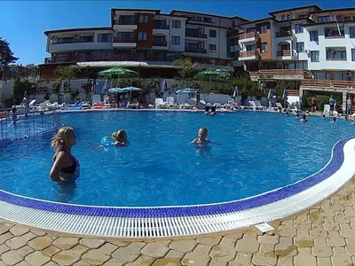 a group of people swimming in a swimming pool at Gardenia Hills Studio in Sunny Beach