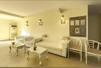a living room with a white couch and tables at Gardenia Hills in Sunny Beach