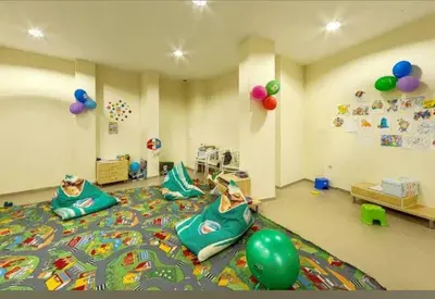 a room with a child laying on a bed at Gardenia Hills in Sunny Beach