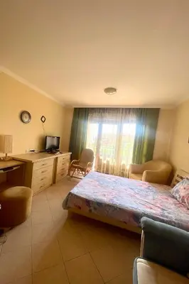 a bedroom with a bed and a desk and a television at Amarena Studio Santa Marina, Sozopol in Sozopol