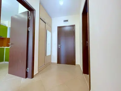 an empty hallway with a wooden door in a building at Sun and Sea A22 in Sunny Beach
