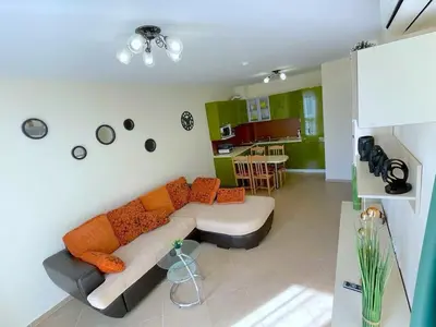 a living room with a couch and a kitchen at Sun and Sea A22 in Sunny Beach