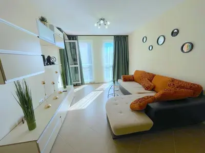 a living room with a couch and a table at Sun and Sea A22 in Sunny Beach