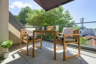 a balcony with a table and chairs on a balcony at INCANTO Residence in Varna City