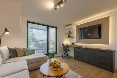 a living room with a couch and a table at INCANTO Residence in Varna City