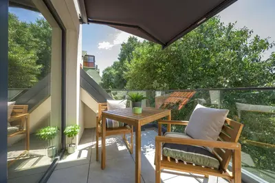 a patio with a table and chairs on a balcony at INCANTO Residence in Varna City