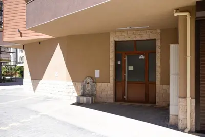 a building with a wooden door on the side of it at Sandy Dreams Cozy Studio in Pomorie