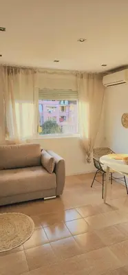 a living room with a couch and a table at The Boho House with Free Parking in Nesebar