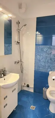 a bathroom with a white sink and a toilet at The Boho House with Free Parking in Nesebar