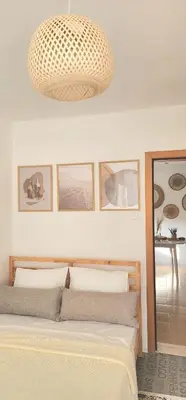 a bedroom with a bed and a pendant light at The Boho House with Free Parking in Nesebar