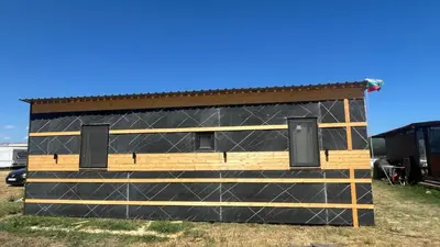 a building with a fence on the side of it at Бунгало woodwave in Chernomorets