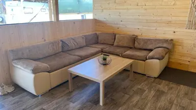 a living room with a couch and a coffee table at Бунгало woodwave in Chernomorets