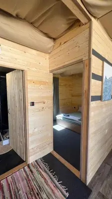 a large wooden cabin with a bed in it at Бунгало woodwave in Chernomorets