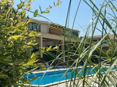 a view of a house from through some grass at Coastal home Arapya in Tsarevo