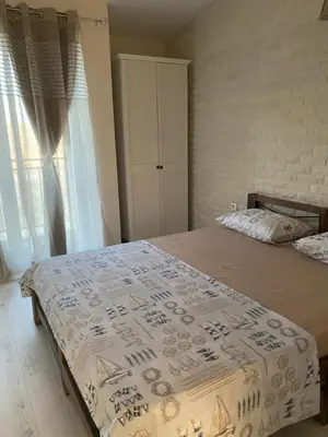 a bedroom with a bed with a white bedspread and a window at Coastal home Arapya in Tsarevo